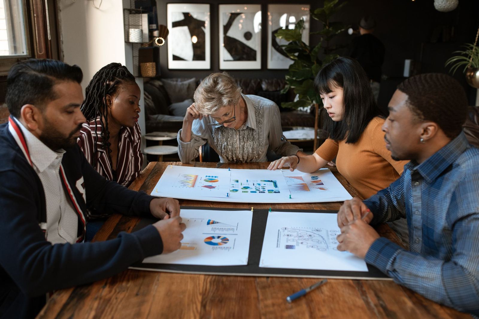A small team planning work together around a table